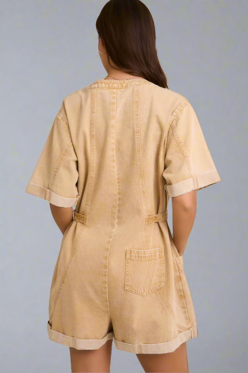 Back of beige romper worn by a woman on a neutral background