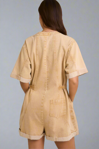Back of beige romper worn by a woman on a neutral background