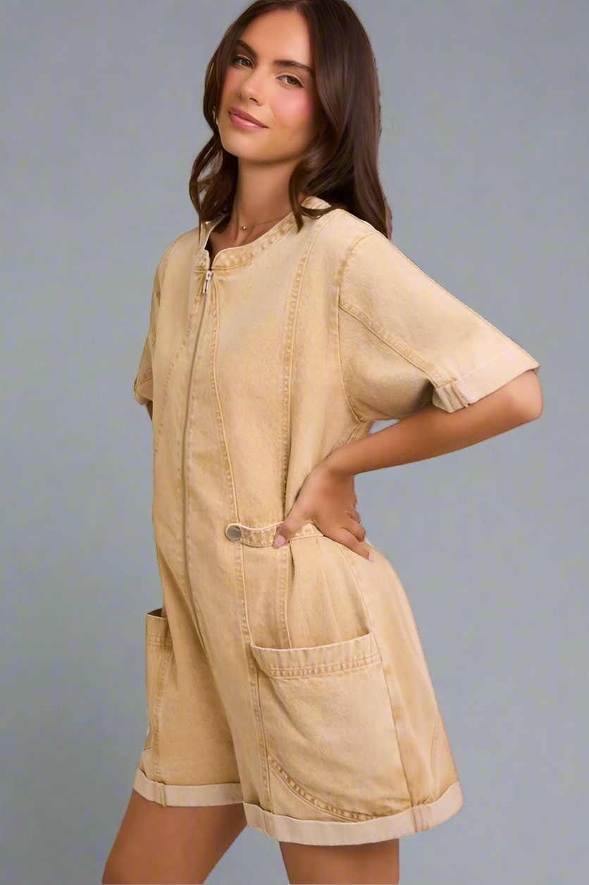 Woman wearing a beige romper with a neutral background