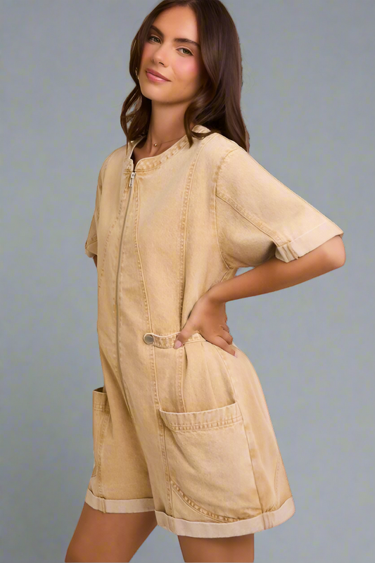 Woman wearing a beige romper with a neutral background