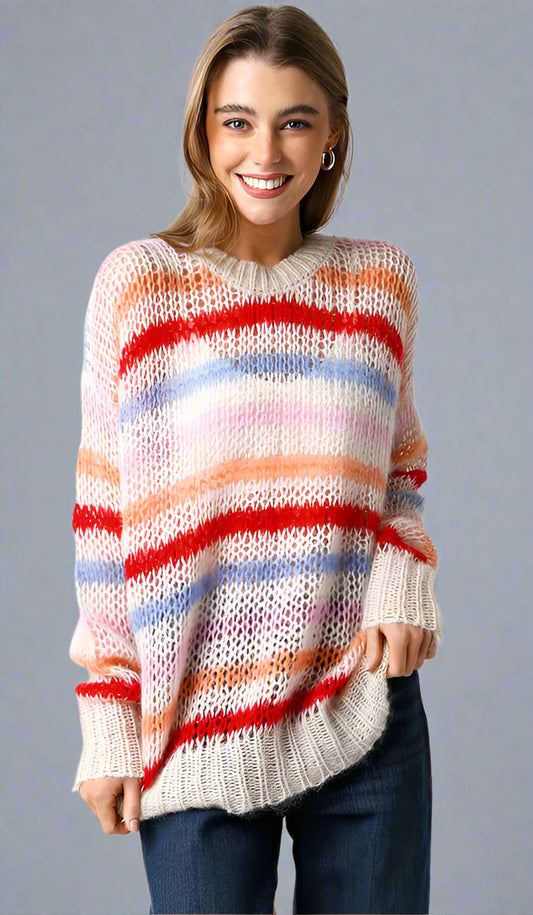 Woman wearing a colorful striped sweater on a neutral background